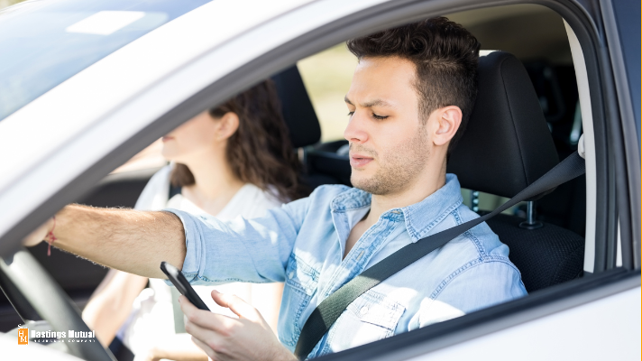 young man texting while driving