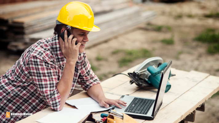 construction contractor with cell phone and computer
