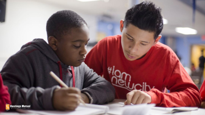 a tutor mentoring a young minority student
