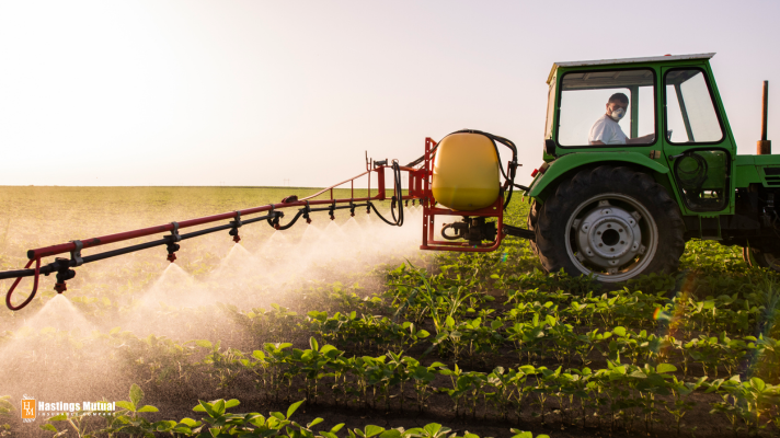 farmer in tractor spraying pesticide