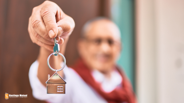 elderly person holding keys to new house